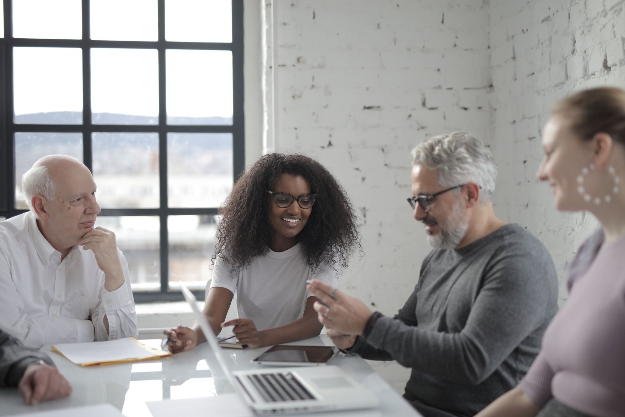 Leadership team in conversation around a conference table
